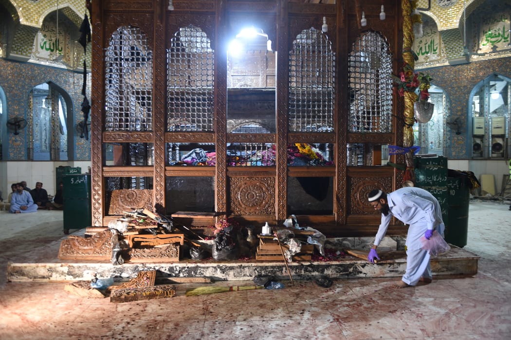 A Pakistani security official collects evidence a day after the bomb attack.