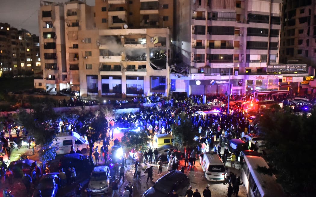 People gather at the site of a strike, reported by Lebanese media to be an Israeli strike targeting a Hamas office, in the southern suburb of Beirut on January 2, 2024. Hamas deputy leader Aruri was killed in an Israeli strike on Beirut's southern suburbs, on January 2, 2024, two security officials told AFP, with state media reporting the strike hit a Hamas office. (Photo by AFP)
