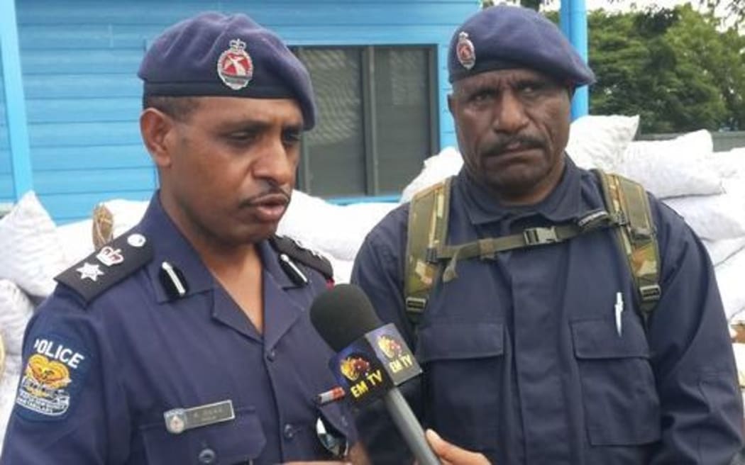 Arrested former police chief of Port Moresby Andy Bawa. (Left)