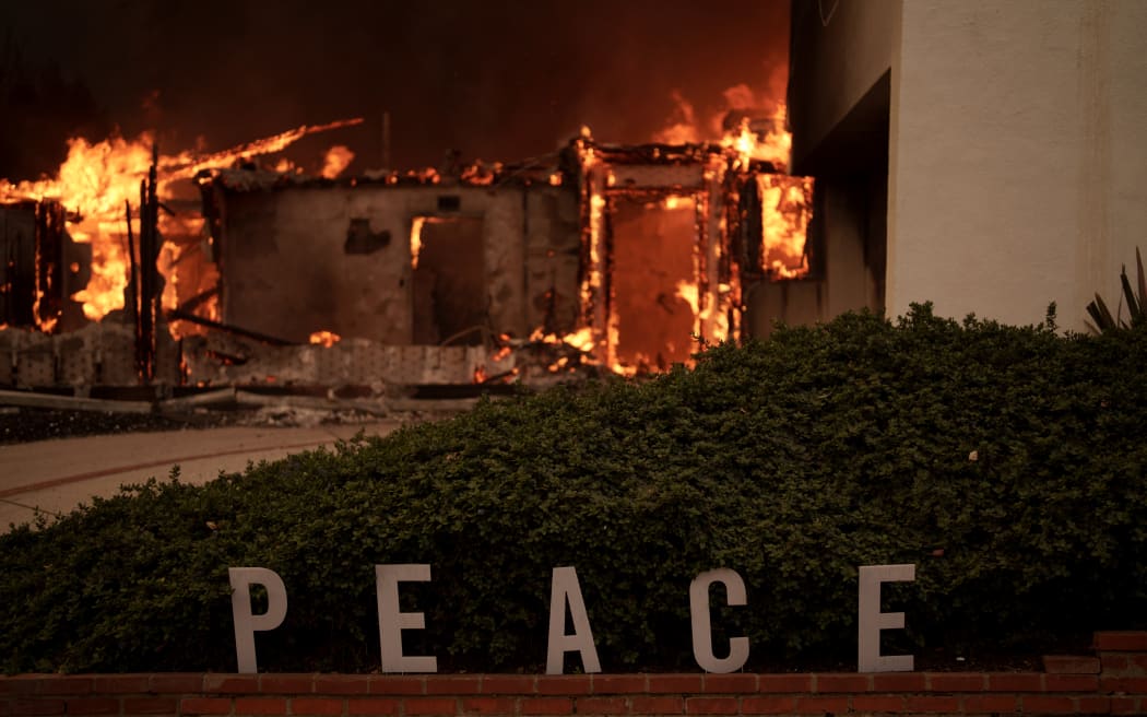 LOS ANGELES, CALIFORNIA - JANUARY 8: Flames from the Palisades Fire burn a home on January 8, 2025 in the Pacific Palisades neighborhood of Los Angeles, California. Multiple wildfires fueled by intense Santa Ana Winds are burning across Los Angeles County. Five people have been killed, over 25,000 acres have burned, and 30,000 people have been evacuated. (Photo by Eric Thayer/Getty Images)