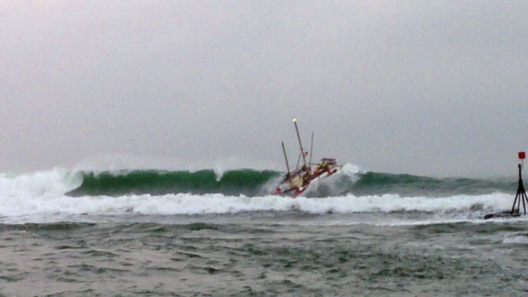 The 2m swell capsized the waka, tossing six men overboard.