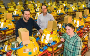 Scientists Dan Bassett, Dan Barker, and Katie Jacobs, all of GNS Science, with some of the recording instruments that will be placed on the seafloor off the East Coast as part of the project to study the Hikurangi subduction zone.