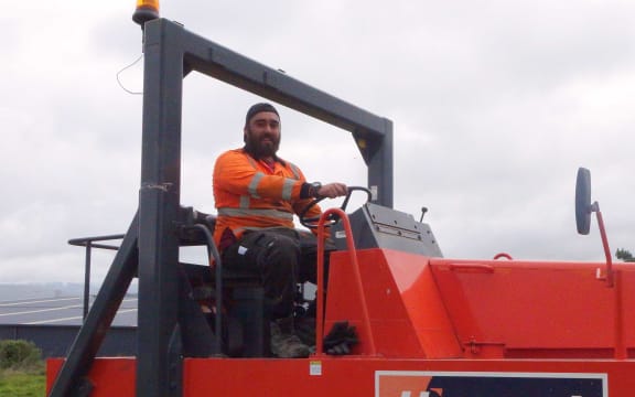Young man driving heavy machinery