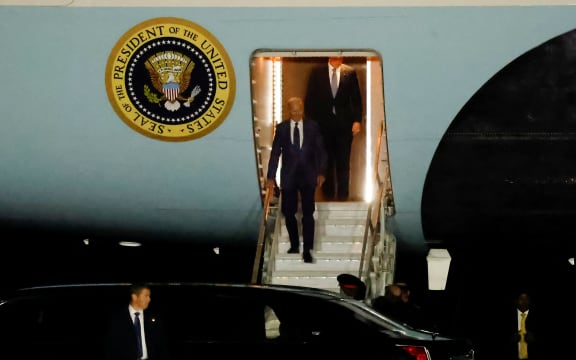 US President Joe Biden disembarks from Air Force One upon arrival at Belfast International Airport on April 11, 2023, starting a four day trip to Northern Ireland and Ireland to launch 25th anniversary commemorations of the "Good Friday Agreement" deal that brought peace to Northern Ireland. - US President Joe Biden arrived in Northern Ireland on Tuesday, hoping to help maintain the fragile peace brokered 25 years ago after decades of sectarian violence over British rule. (Photo by CLODAGH KILCOYNE / POOL / AFP)