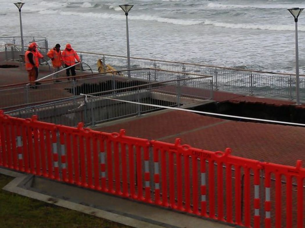 Workers inspecting the sink-holes in June.