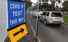 People queue in their cars at a Covid-19 testing station in Melbourne on 25 May 2021 as the city recorded new coronavirus cases in the community.