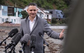 Climate Change Minister James Shaw speaks to media at Owhio Bay, which has been slammed by repeated storms, after revealing the National Adaptation Plan