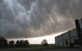 Severe storm clouds move across the northwest edge of Davenport, Iowa on Friday, May 24, 2024. Several tornadoes were reported in Iowa and Illinois as storms downed power lines and trees on Friday, just after a deadly twister devastated one small town.(Roy Dabner/Quad City Times via AP)