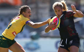 Atawhai Tupaea of the Kiwi Ferns is scragged by a Jilaroos player.