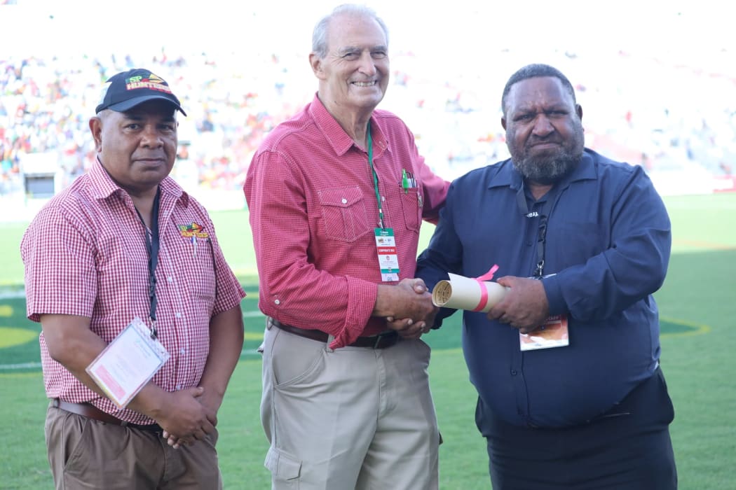 Don Fox receiving his PNGRFL life membership from Chairman Sandis Tsaka in 2019, accompanied by CEO Reatau Rau.