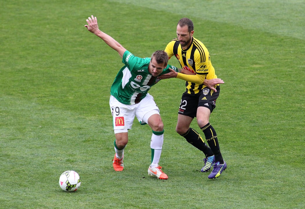 Jets' Joel Griffiths holds off the challenge from Phoenix' Andrew Durante during their A-League Football Match - Phoenix v Newcastle at the Westpac Stadium in Wellington on 26th of October 2014.