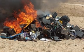 This handout photograph taken on July 29, 2023 and released by the Afghanistan's Ministry for the Propagation of Virtue and the Prevention of Vice shows a pile of musical instruments and equipments being set on fire by the members of Taliban on the outskirts of Herat. Authorities from Afghanistan's vice ministry created a bonfire of confiscated musicial instruments and equipment in Herat province at the weekend, deeming music immoral. (Photo by Afghanistan's Ministry for the Propagation of Virtue and the Prevention of Vice / AFP) / RESTRICTED TO EDITORIAL USE - MANDATORY CREDIT "AFP PHOTO/Afghanistan's Ministry for the Propagation of Virtue and the Prevention of Vice" - NO MARKETING NO ADVERTISING CAMPAIGNS - DISTRIBUTED AS A SERVICE TO CLIENTS