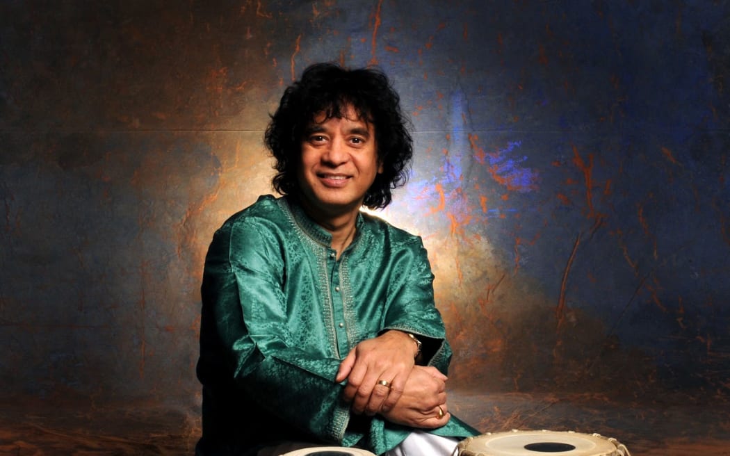 Zahir Hussain is pictured with his tabla in the foreground.