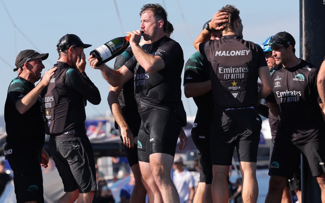 The members of crew of defender Emirates Team New Zealand celebrate beating Britain's Ineos Britannia and winning the Louis Vuitton 37th America's Cup Match, in Barcelona on October 19, 2024.