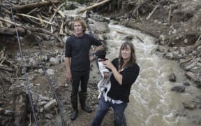 Barrytown was hit hard in former Tropical Cyclone Gita. Rita Bennett and her neighbour Mark Clisby repair a water pipe after a massive slip ripped through the property.