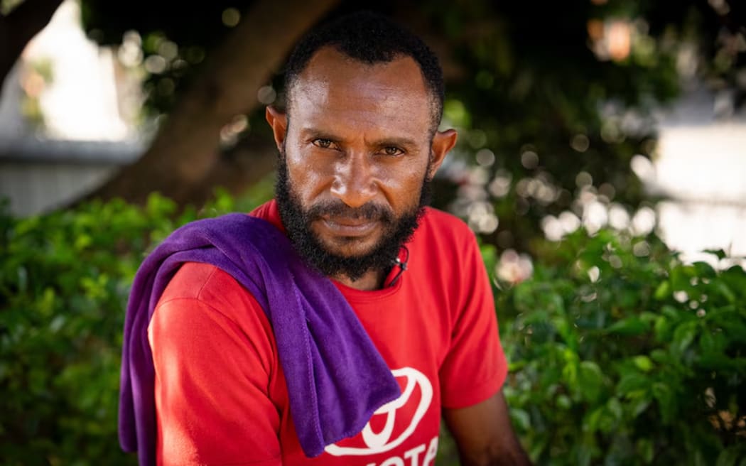 Father Kevin Mitiam is a twin himself, and hopes his newborn sons will both survive. (ABC News: Marian Faa)