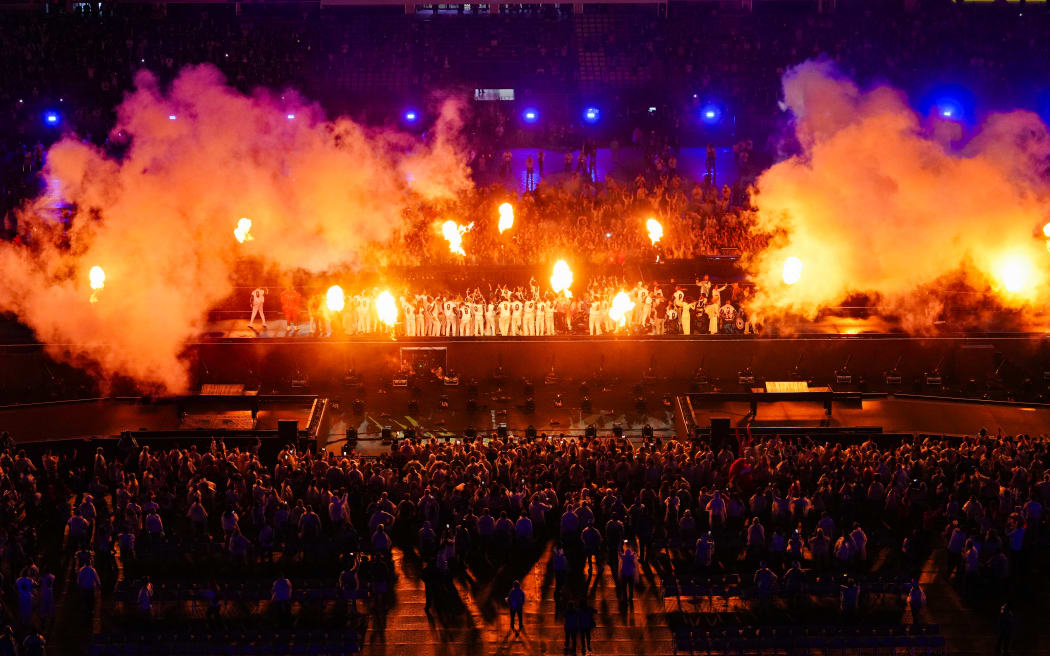 French athletes on stage as fireworks explode during the Paris 2024 Paralympic Games Closing Ceremony at the Stade de France.