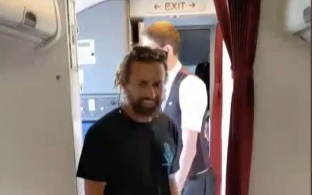 Andre Rerekura re-entering the plane after taking a non-venomous Stimson's python off the aircraft.