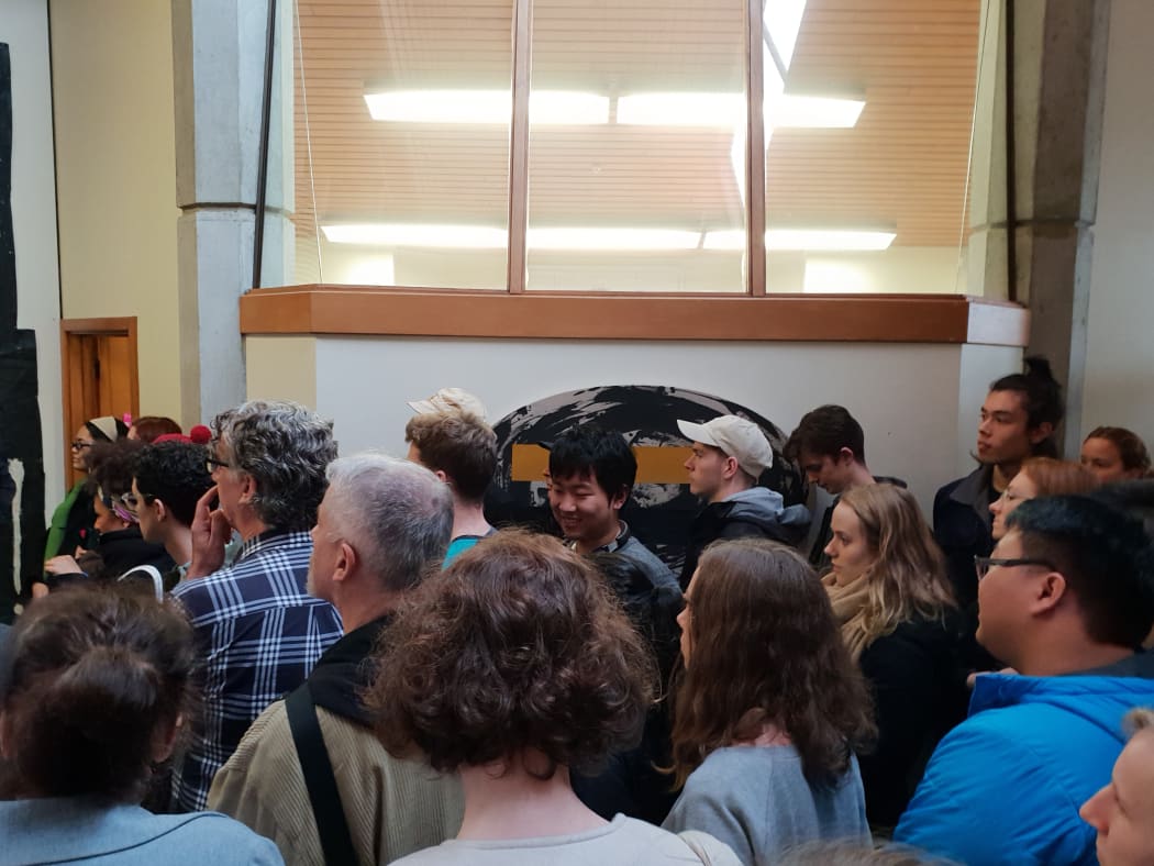 Dozens packed a small corridor outside the Dean of the Creative Arts and Industries department on 21 June to protest against the closure of three specialist libraries on University of Auckland's campus.