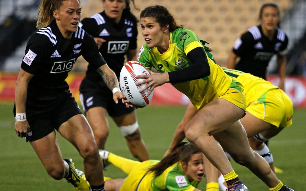Australia's Charlotte Caslick breaks New Zealand's defence.