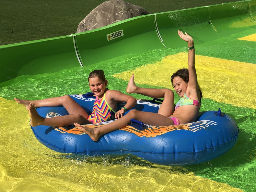 Tahlia Bresson, 8 and Tenesha Hey, 9, enjoy the Conical Thrill waterslide at Hanmer Springs on its opening day.
