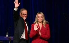 Australia's Prime Minister Anthony Albanese waves beside his partner Jodie Haydon after winning the general election at the Labor Party election night event in Sydney on 3 May, 2025.