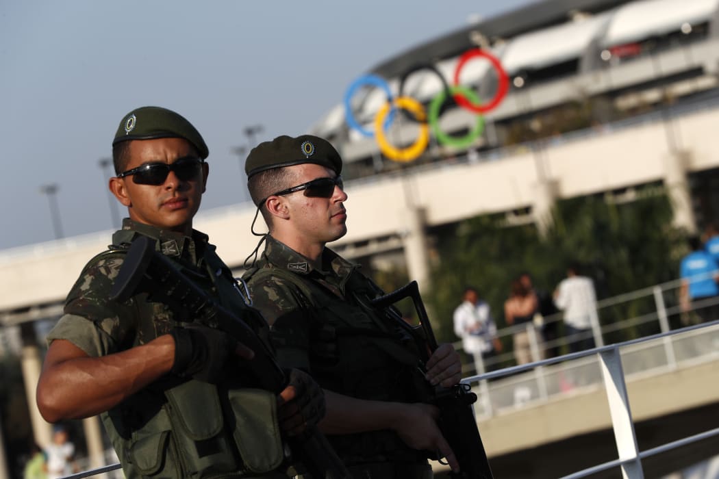 Brazilian security forces stand guard outside the Maracana stadium in Rio de Janeiro, ahead of the opening ceremony.