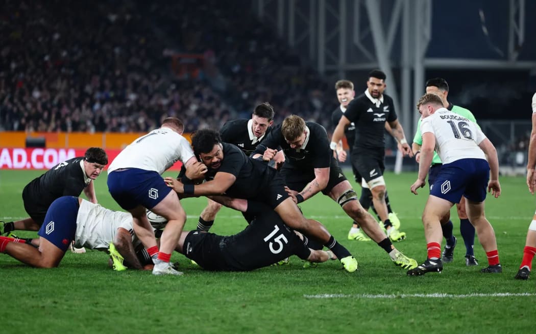 Pasilio Tosi clears out a ruck against France.
