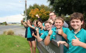 Longbeach School principal Neil Simons with pupils (front to back) Harry O'Connell, George Lash, Hunter Illingworth, Principal Neil Simons, Benji Skevington, Henry Pottinger, Grace Harrison-Hastie, and Rose McKay.