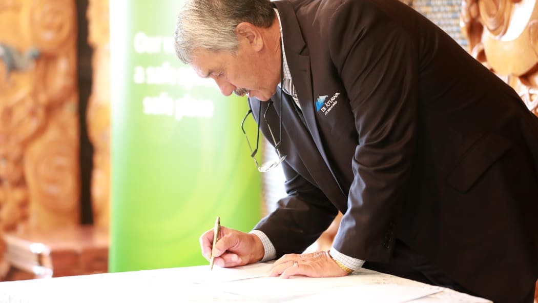 Te Ātiawa o Te Waka-a-Māui trustee Ron Riwaka signs the kawenata (agreement) with KiwiRail in March last year.