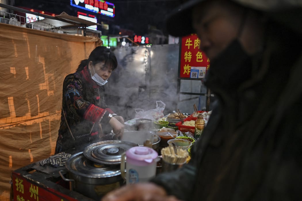 A food seller waits for clients at a market in Wuhan, China's central Hubei province this month.