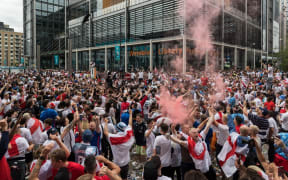 LONDON, UNITED KINGDOM - JULY 11, 2021: England football fans celebrate outside Wembley Stadium ahead of England match against Italy in the final of Euro 2020 Championship on July 11, 2021 in London, England.