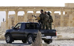 Members of the Syrian army patrol the ancient Syrian city of Palmyra on 6 May 2016.