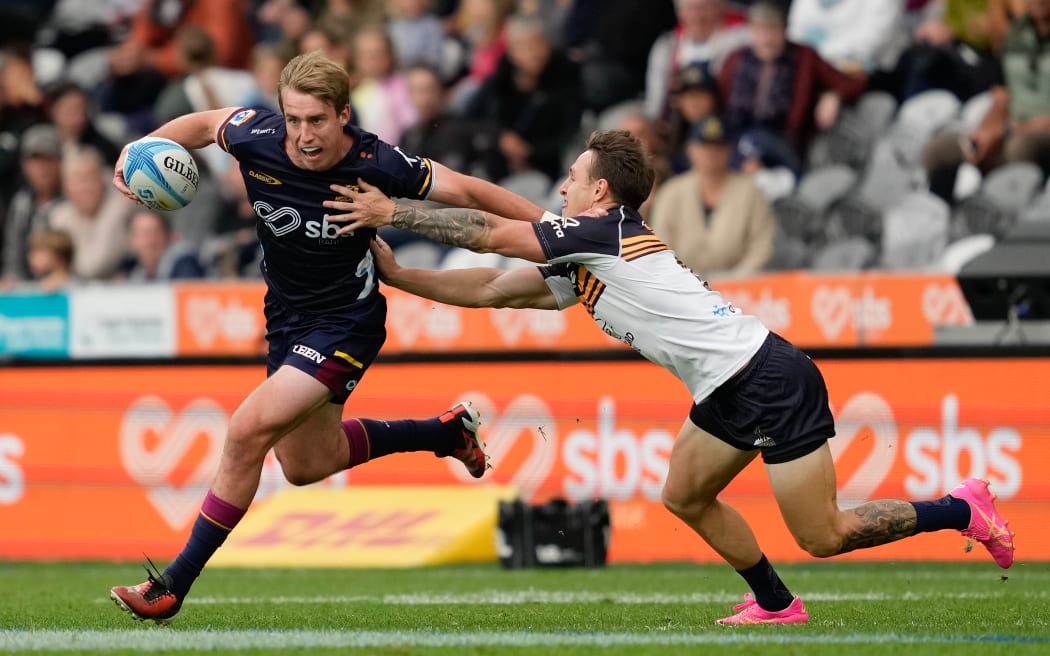 Cameron Millar looks to palm off a Brumbies defender.