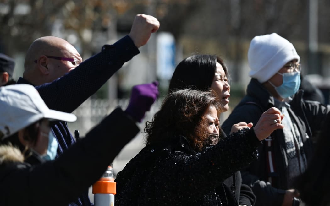 Relatives of passengers who were on board the missing Malaysia Airlines flight MH370 chant demands outside the Malaysian embassy in Beijing on 8 March, 2024, on the 10th anniversary of the flight’s disappearance.