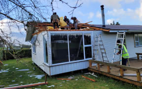 Clean-up continues on Kaponga dairy farmer Shelley Pope's property after overnight storms.