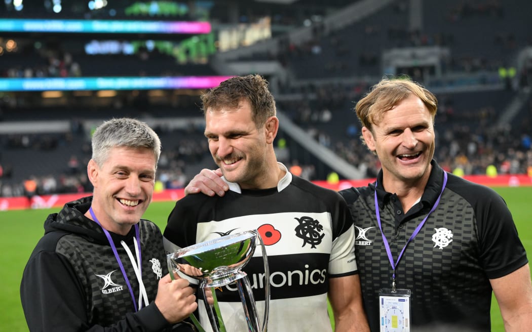 Ronan O'Gara, Luke Whitelock and Scott Robertson celebrate victory for the Barbarians over the All Blacks XV.