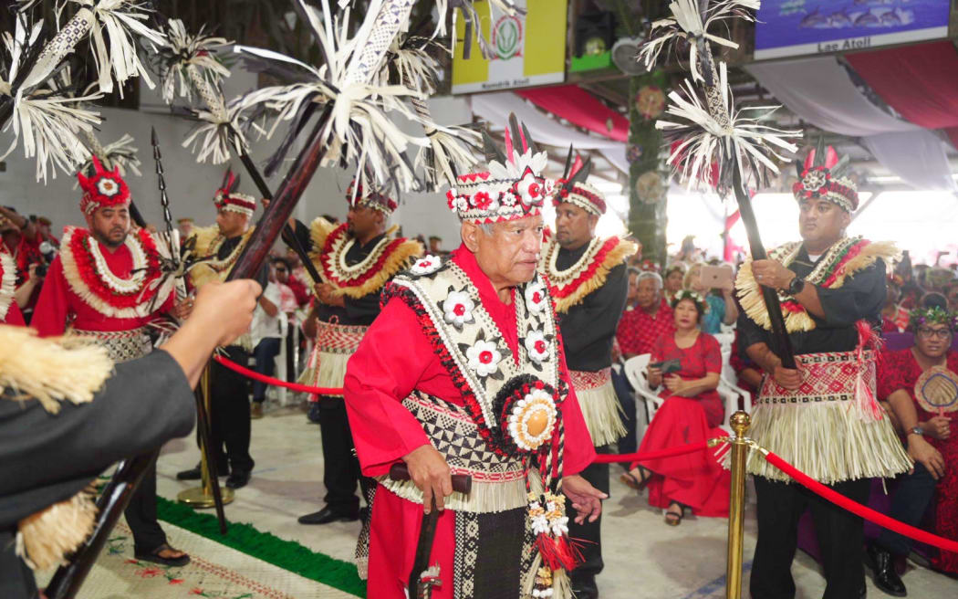 Iroojlaplap (paramount chief) Michael Kabua walks through an honor guard of spear-holding warriors representing the 12 atolls and single islands in his domain at the start of a gala coronation ceremony in the Marshall Islands Thursday night. Thousands of people were on hand to witness the event, the first Kabua royal family coronation in half a century. Photo: Chewy Lin.