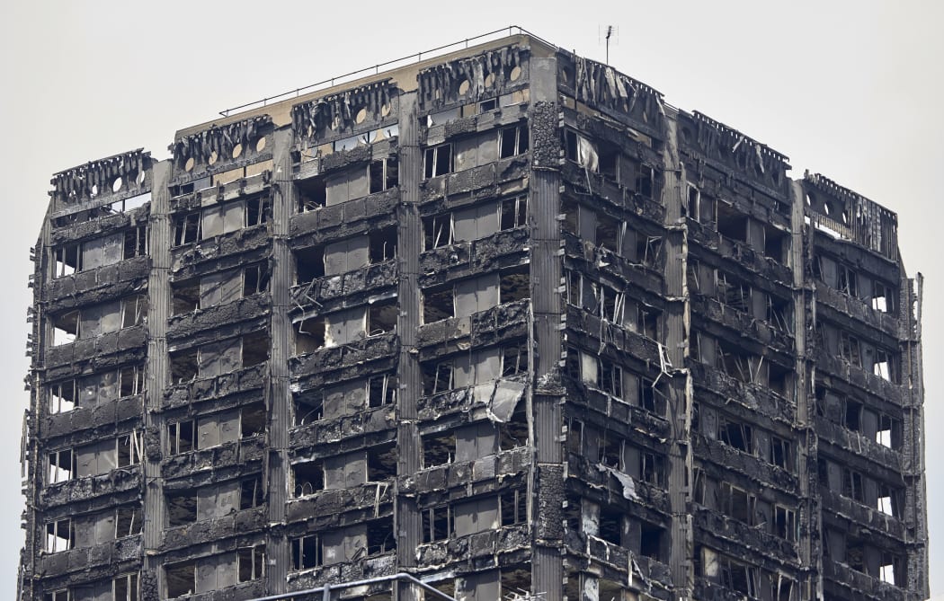 The charred remains of cladding are pictured on the outer walls of the burnt out shell of the Grenfell Tower block in north Kensington, west London, on June 22, 2017.