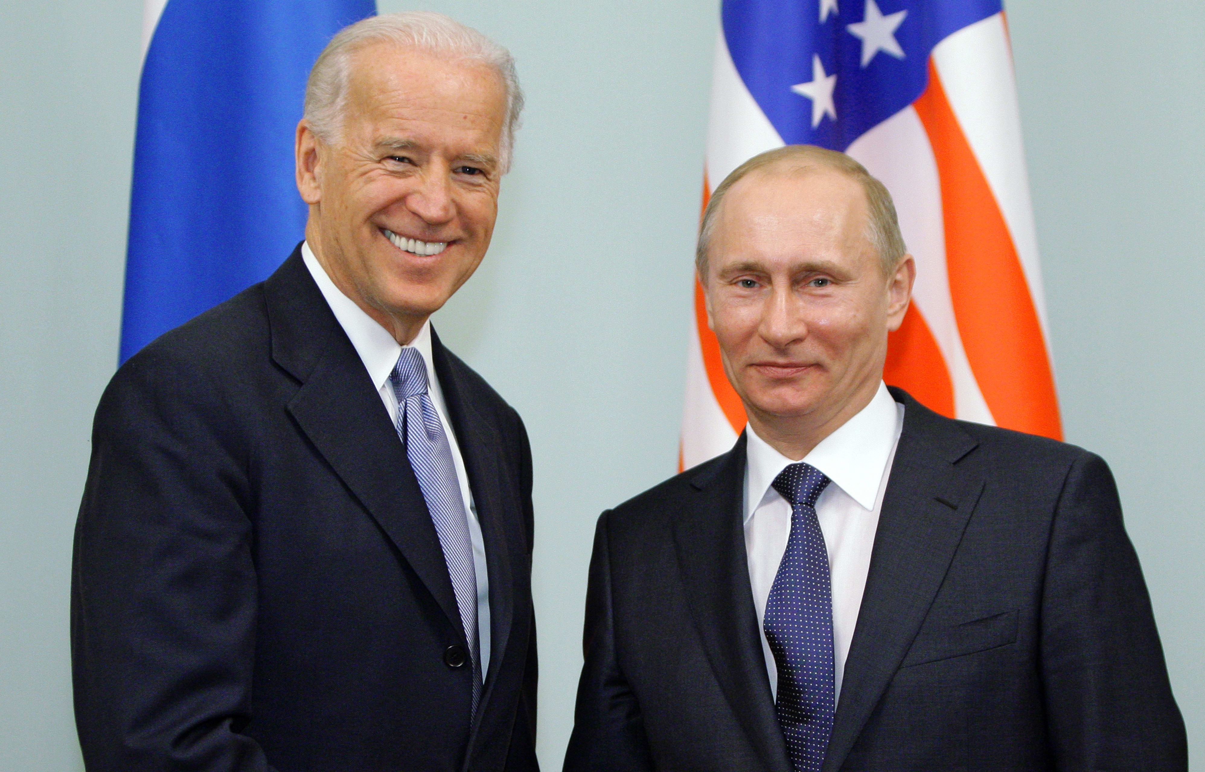 (FILES) In this file photo taken on March 10, 2011, Russian Prime Minister Vladimir Putin (R) shakes hands with US Vice President Joe Biden during their meeting in Moscow.