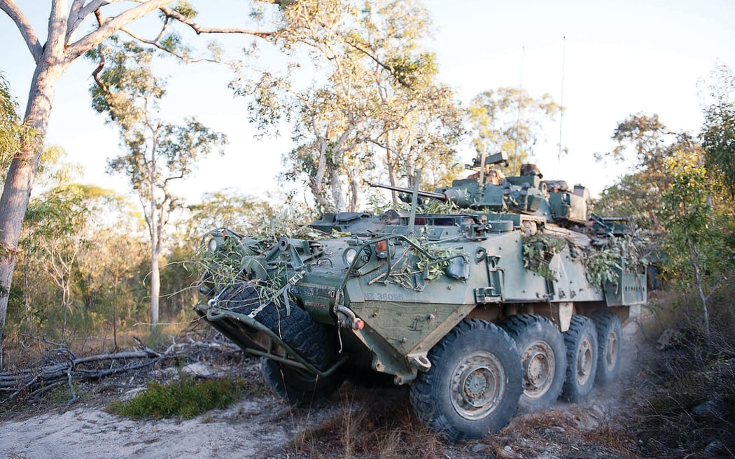 A New Zealand Defence Force tank driving through the bush.