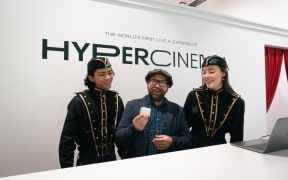 Miles Gregory (centre) at the entrance of Hypercinema.