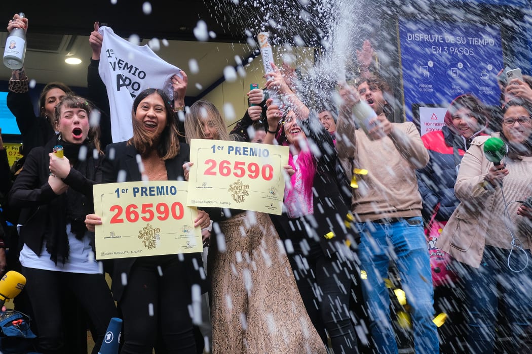 Madrid lottery shop Dona Manolita employees celebrate having sold the winning number in the €4m ''El Gordo'' (Fat One) Christmas lottery, on 22 December