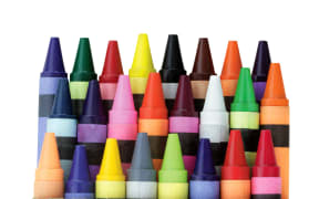 Three rows of wax crayons in a box