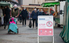 A sign showing Covid-19 measures at the weekly market in the district of Biberach, southern Germany.