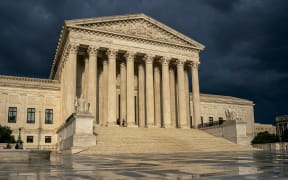 FILE - The Supreme Court is seen under stormy skies in Washington, June 20, 2019. In the coming days, the Supreme Court will confront a perfect storm mostly of its own making, a trio of decisions stemming directly from the Jan. 6, 2021 attack on the U.S. Capitol.  (AP Photo/J. Scott Applewhite, File)