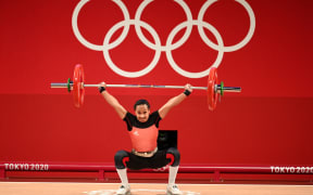 Dika Toua competes in the women's 49kg weightlifting competition during the Tokyo 2020 Olympic Games in Tokyo.