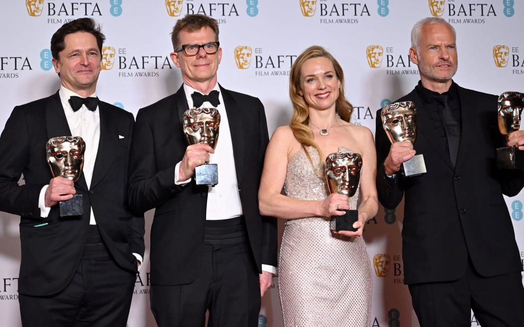 (L-R) British movie producer Pete Czernin, British movie producer Graham Broadbent, Irish actress Kerry Condon and British-Irish screenwriter and movie director Martin McDonagh pose with their awards for 'The Banshees of Inisherin' during the BAFTA British Academy Film Awards ceremony at the Royal Festival Hall, Southbank Centre, in London, on February 19, 2023. (Photo by JUSTIN TALLIS / AFP)