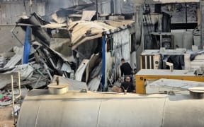 People check the damage outside the Kamal Adwan hospital in Beit Lahia in the northern Gaza Strip, following Israeli strikes around the medical complex.