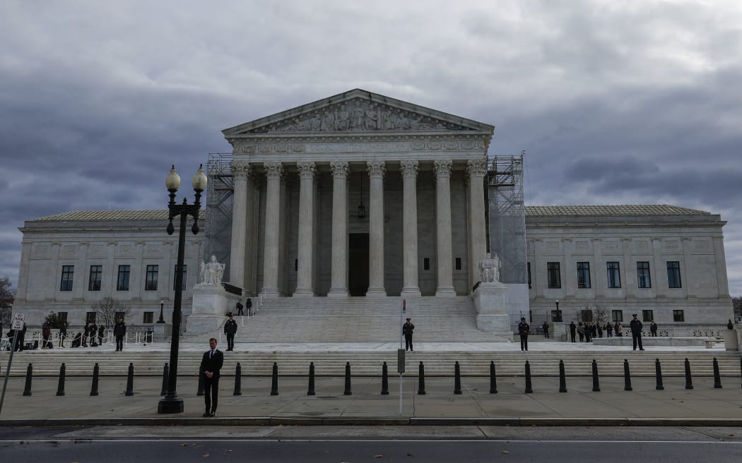 WASHINGTON, DC - DECEMBER 18: Flags fly at half-staff on the front plaza of the U.S. Supreme Court Building before the funeral service for retired Supreme Court Justice Sandra Day O'Connor on December 18, 2023 in Washington, DC. O’Connor, who was the first woman appointed to be a justice on the U.S. Supreme Court, died at the age of 93 on December 1, 2023.   Anna Moneymaker/Getty Images/AFP (Photo by Anna Moneymaker / GETTY IMAGES NORTH AMERICA / Getty Images via AFP)